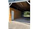 Open barn with concrete floor, wood paneling, and access to paddocks at 6726 Nw 54Th Loop, Ocala, FL 34482