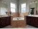 Lavish bathroom featuring dual sinks and a standalone tub with natural light at 6726 Nw 54Th Loop, Ocala, FL 34482