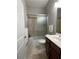 Full bathroom features a shower-tub combo with a sliding glass door at 6726 Nw 54Th Loop, Ocala, FL 34482