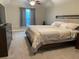 Comfortable bedroom with large bed, neutral carpet, and a ceiling fan at 6726 Nw 54Th Loop, Ocala, FL 34482