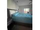 Spacious bedroom featuring a large bed and bathroom access at 6726 Nw 54Th Loop, Ocala, FL 34482