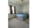 Well-lit bedroom with large window, ceiling fan, and neutral carpet at 6726 Nw 54Th Loop, Ocala, FL 34482