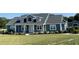 Charming two-story home boasts a manicured lawn and classic architectural details at 6726 Nw 54Th Loop, Ocala, FL 34482