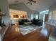 Open concept living room with fireplace, hardwood floors, and ample seating at 6726 Nw 54Th Loop, Ocala, FL 34482