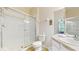 Clean bathroom featuring a glass-enclosed shower and neutral color palette at 7654 Comrow St # 202, Kissimmee, FL 34747