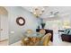 Well-lit dining area adjacent to the living room, featuring tile floors, a ceiling fan, and stylish decor at 7654 Comrow St # 202, Kissimmee, FL 34747