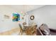 Cozy dining area featuring a glass table with wicker chairs and a pass-through to the kitchen at 7654 Comrow St # 202, Kissimmee, FL 34747