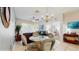 Charming dining area with a glass-top table, wicker chairs, and views of the living room and bedroom at 7654 Comrow St # 202, Kissimmee, FL 34747