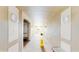 Long, neutral hallway featuring overhead lighting, benches and views of exterior at 7654 Comrow St # 202, Kissimmee, FL 34747