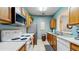 Efficient kitchen with ample counter space, stainless steel appliances, and a pass-through to the dining area at 7654 Comrow St # 202, Kissimmee, FL 34747