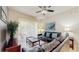 Bright living room with tile flooring, a ceiling fan, patio access, and a comfortable seating arrangement at 7654 Comrow St # 202, Kissimmee, FL 34747