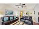 Comfortable living room with large leather sofas, ceiling fan, decor, and seamless flow into the dining area at 7654 Comrow St # 202, Kissimmee, FL 34747