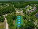 Aerial view of multiple tennis courts and luscious green landscaping in a planned community at 24 Lake Vista Way, Ormond Beach, FL 32174