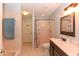 Bathroom featuring a double sink vanity with dark wood cabinets, a walk-in shower and a tub at 24 Lake Vista Way, Ormond Beach, FL 32174
