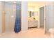 Bathroom with tiled walk-in shower, toilet, vanity with a double sink and light colored tile flooring at 24 Lake Vista Way, Ormond Beach, FL 32174