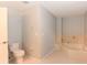 Bright bathroom featuring a corner bathtub with tile surround and a standard toilet at 24 Lake Vista Way, Ormond Beach, FL 32174
