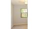 Bedroom featuring neutral colored carpet, light gray walls, and a window at 24 Lake Vista Way, Ormond Beach, FL 32174