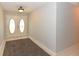 Welcoming foyer with double doors, neutral walls, and a convenient rug for added comfort at 24 Lake Vista Way, Ormond Beach, FL 32174