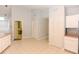 Well-lit kitchen with tile floors, pantry storage, and access to a full bathroom at 24 Lake Vista Way, Ormond Beach, FL 32174