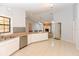 Spacious kitchen with stainless steel dishwasher, plenty of cabinets, counter space and tile flooring at 24 Lake Vista Way, Ormond Beach, FL 32174