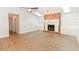 Living room featuring a brick fireplace, built-in shelving, vaulted ceilings, and lots of natural light at 24 Lake Vista Way, Ormond Beach, FL 32174
