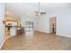 Spacious living room featuring hardwood floors, modern ceiling fan, and access to a pool via sliding glass doors at 24 Lake Vista Way, Ormond Beach, FL 32174