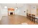 Open living room with vaulted ceilings, fireplace, built-in cabinets, and a ceiling fan at 24 Lake Vista Way, Ormond Beach, FL 32174