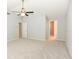 Spacious main bedroom with carpet, neutral walls, ceiling fan, and two entryways at 24 Lake Vista Way, Ormond Beach, FL 32174