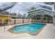 Backyard pool with a screened enclosure and a beige concrete deck and lush landscaping at 24 Lake Vista Way, Ormond Beach, FL 32174