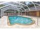 Backyard pool with a screened enclosure and a concrete deck and access to the brick house at 24 Lake Vista Way, Ormond Beach, FL 32174