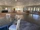 Spacious recreation room with neutral carpeting and multiple tables and chairs for events at 24 Lake Vista Way, Ormond Beach, FL 32174