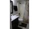 Bathroom with tiled shower/bath combo, bronze fixtures, and a granite sink. The shower curtain has a map design at 1048 Winding Water Way, Clermont, FL 34714