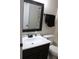 Bathroom features a sink with a dark vanity and bronze fixtures, toilet and tiled tub/shower combo at 1048 Winding Water Way, Clermont, FL 34714
