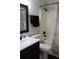 Cozy bathroom with tiled shower/bath combo, dark bronze fixtures, and a granite sink. Shower curtain has map pattern at 1048 Winding Water Way, Clermont, FL 34714