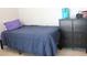 Cozy bedroom features a single bed, small dresser, and tile flooring at 1048 Winding Water Way, Clermont, FL 34714