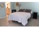 Inviting bedroom with neutral tones, tile flooring, and an en-suite bathroom for added convenience at 1048 Winding Water Way, Clermont, FL 34714
