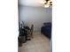 Simple bedroom design with tile floors, a workspace, and a single bed at 1048 Winding Water Way, Clermont, FL 34714