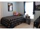 Well-lit bedroom featuring a cozy twin bed, a small table and a window offering natural light and space at 1048 Winding Water Way, Clermont, FL 34714