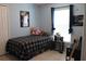 Light bedroom featuring a cozy twin bed, small table and a window offering natural light and a comfortable feel at 1048 Winding Water Way, Clermont, FL 34714