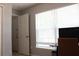 Corner bedroom with door, window, tile floor, and functional work space at 1048 Winding Water Way, Clermont, FL 34714