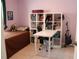 Cozy bedroom features a single bed, white bookshelf, and a white desk, offering space for relaxation and study at 1048 Winding Water Way, Clermont, FL 34714