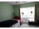 Bright bedroom featuring a twin bed, plants, and a window offering natural light, creating a tranquil atmosphere at 1048 Winding Water Way, Clermont, FL 34714