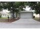 Charming one-story home with a well-maintained lawn and attached two-car garage at 1048 Winding Water Way, Clermont, FL 34714