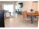 Bright, open floor plan with tile flooring, modern furniture, and sliding glass doors at 1048 Winding Water Way, Clermont, FL 34714
