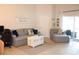 Relaxing living area with a comfortable sofa, natural light, and stylish decor at 1048 Winding Water Way, Clermont, FL 34714