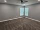 Spacious bedroom featuring plush carpet, a ceiling fan, and bright natural light from the windows at 1121 W 9Th St, Lakeland, FL 33805