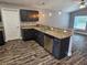 Well-appointed kitchen featuring stainless steel appliances, granite countertops and sleek wooden cabinets and flooring at 1121 W 9Th St, Lakeland, FL 33805
