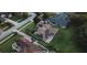 An aerial view of the home featuring solar panels and a backyard patio at 16325 Magnolia Bluff Dr, Montverde, FL 34756
