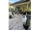Covered patio area featuring an outdoor seating, beautiful plants and a fire pit at 16325 Magnolia Bluff Dr, Montverde, FL 34756