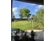 View of the spacious backyard from the covered patio, featuring string lights and lush green landscaping at 16325 Magnolia Bluff Dr, Montverde, FL 34756
